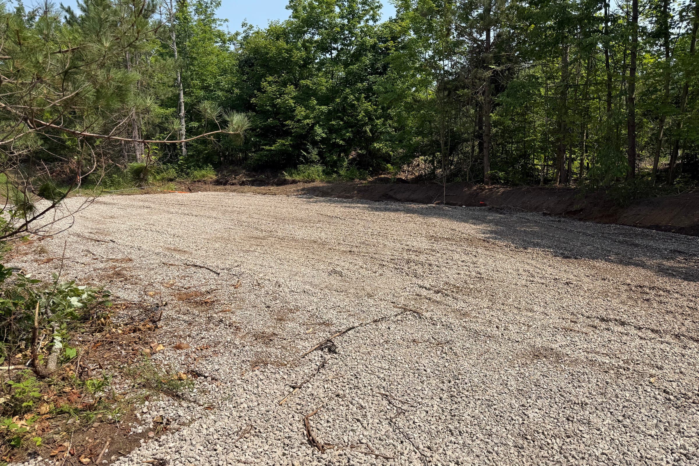 New gravel pad being finished with a compact excavator