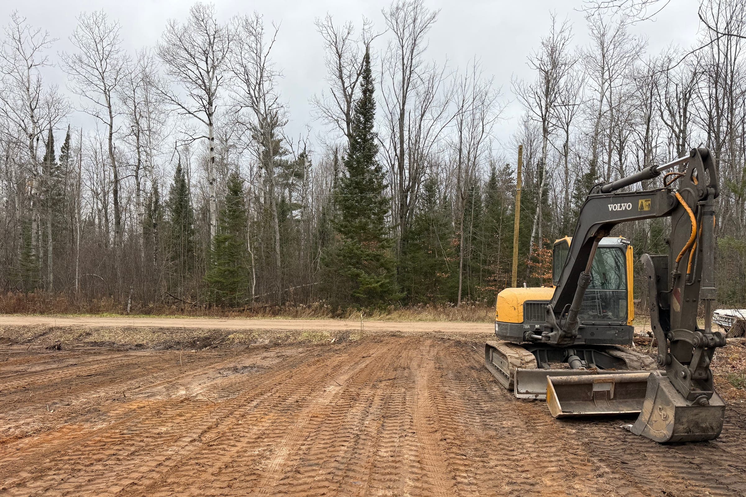 Excavator parked on a freshly graded construction site
