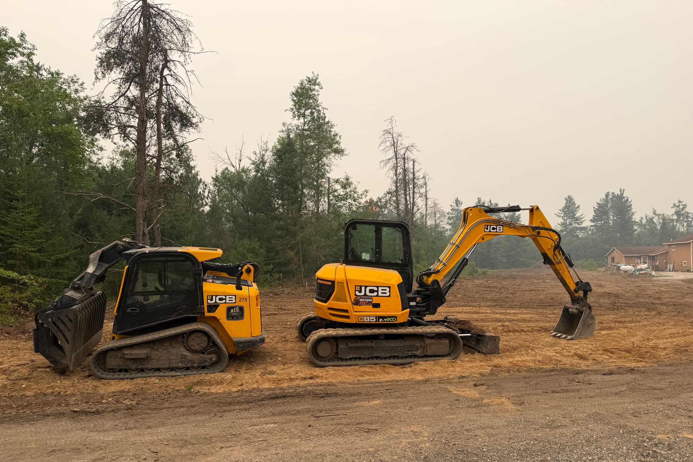 Northern Dirt excavator and compact track loader on site
