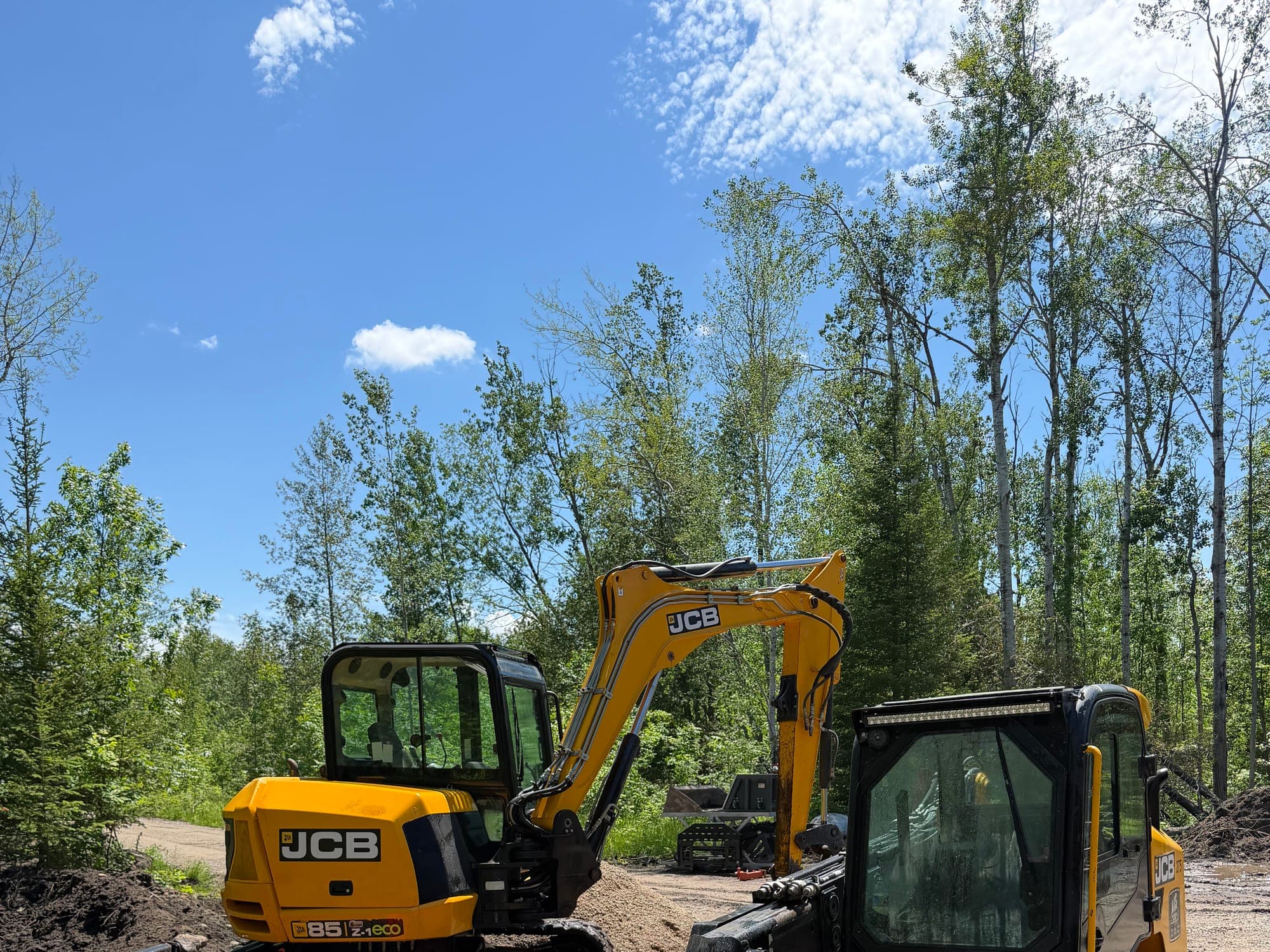 Northern Dirt excavators staged together on a job site