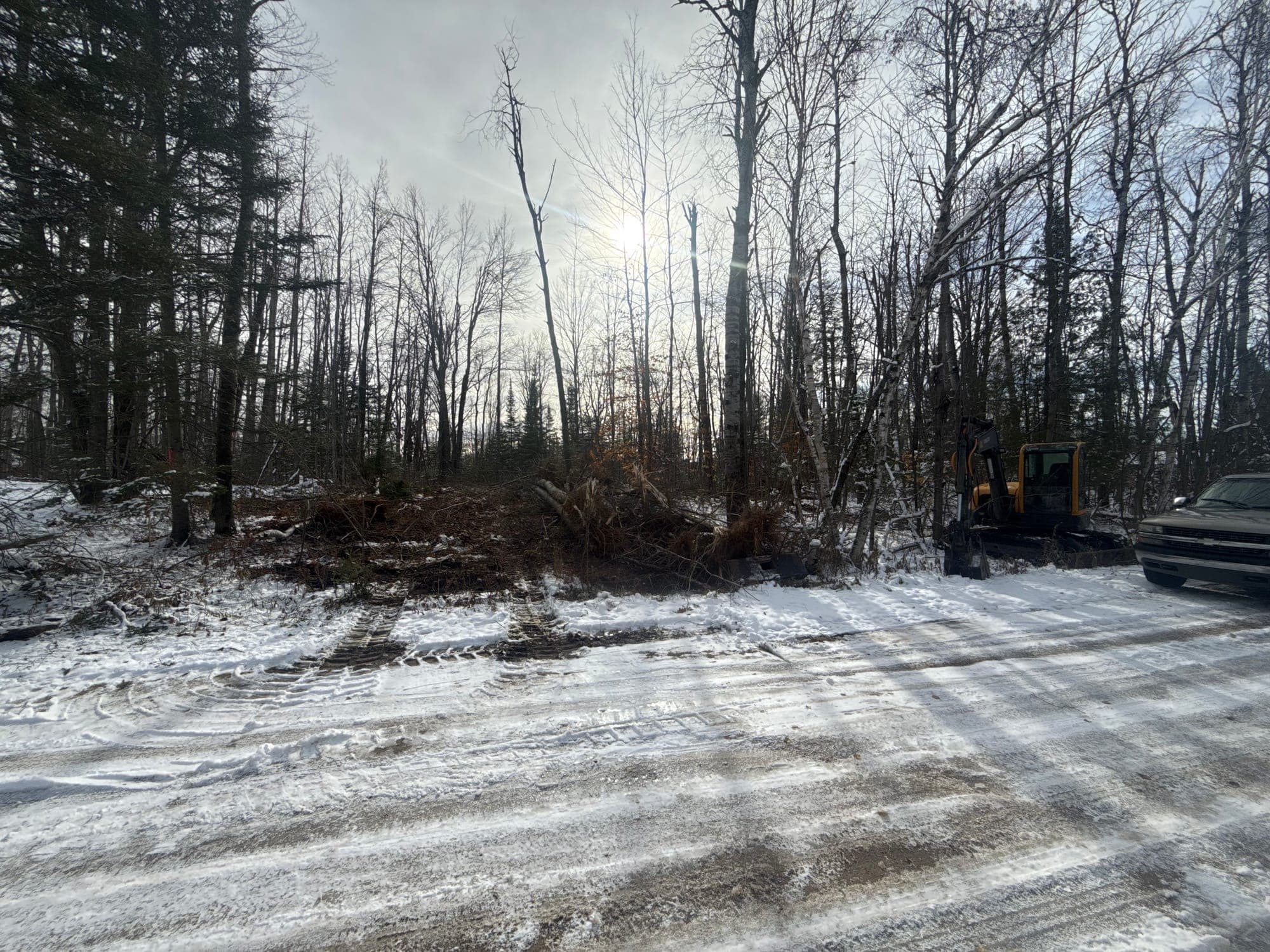 Winter debris clearing and access restoration along a snowy road